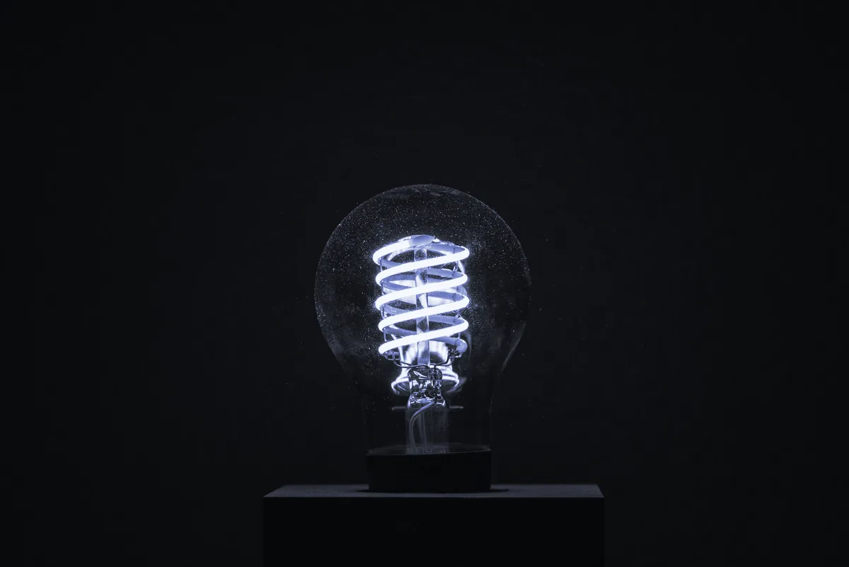 Bombilla de filamento encendida sobre un fondo oscuro