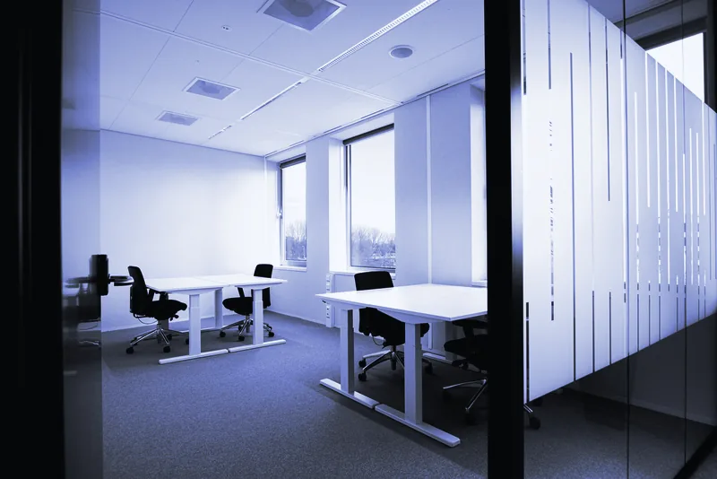 Puestos de trabajo con mesas blancas en una oficina luminosa