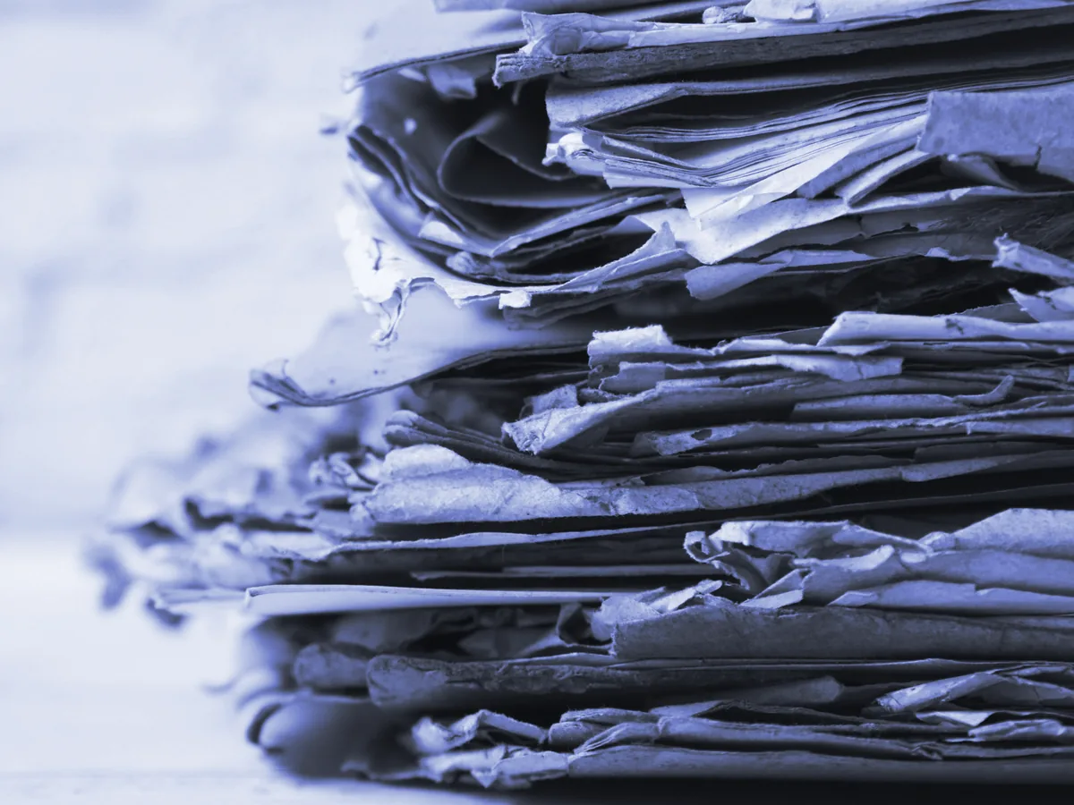 Pila de papeles y documentos amontonados sobre una mesa